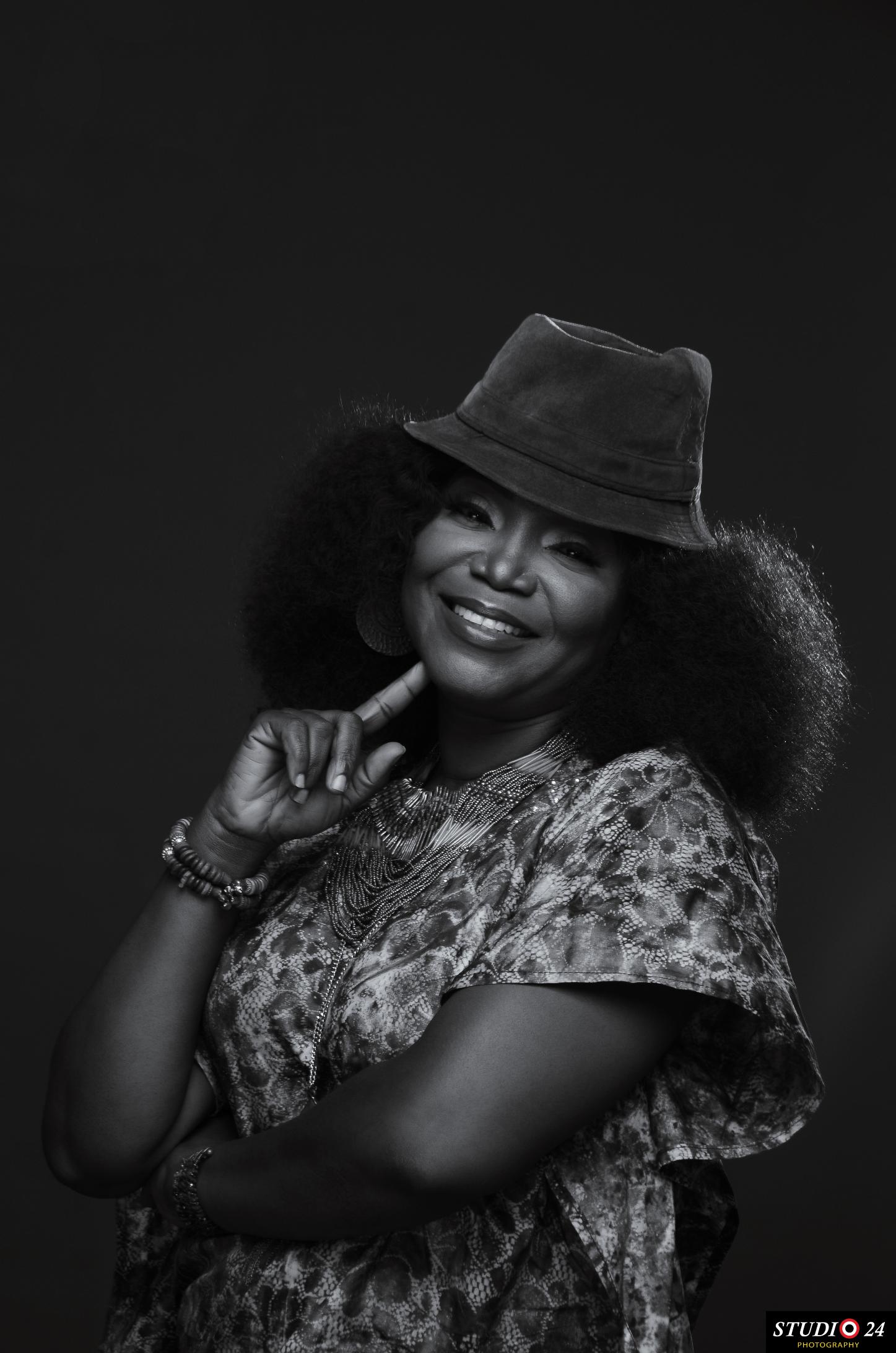 Temitope smiling in a black and white studio portrait